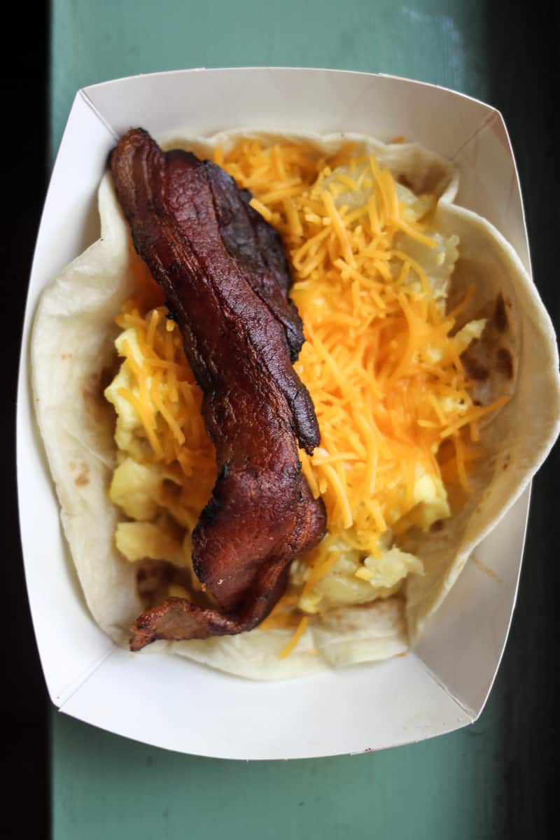 Tamale House East's breakfast taco with bacon, egg, potato, and cheese