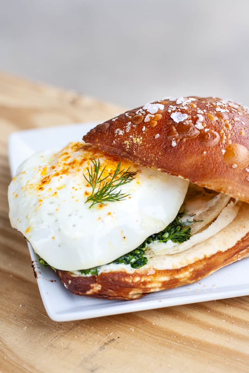 breakfast sandwich served on a bavarian croissant by Ovenbird