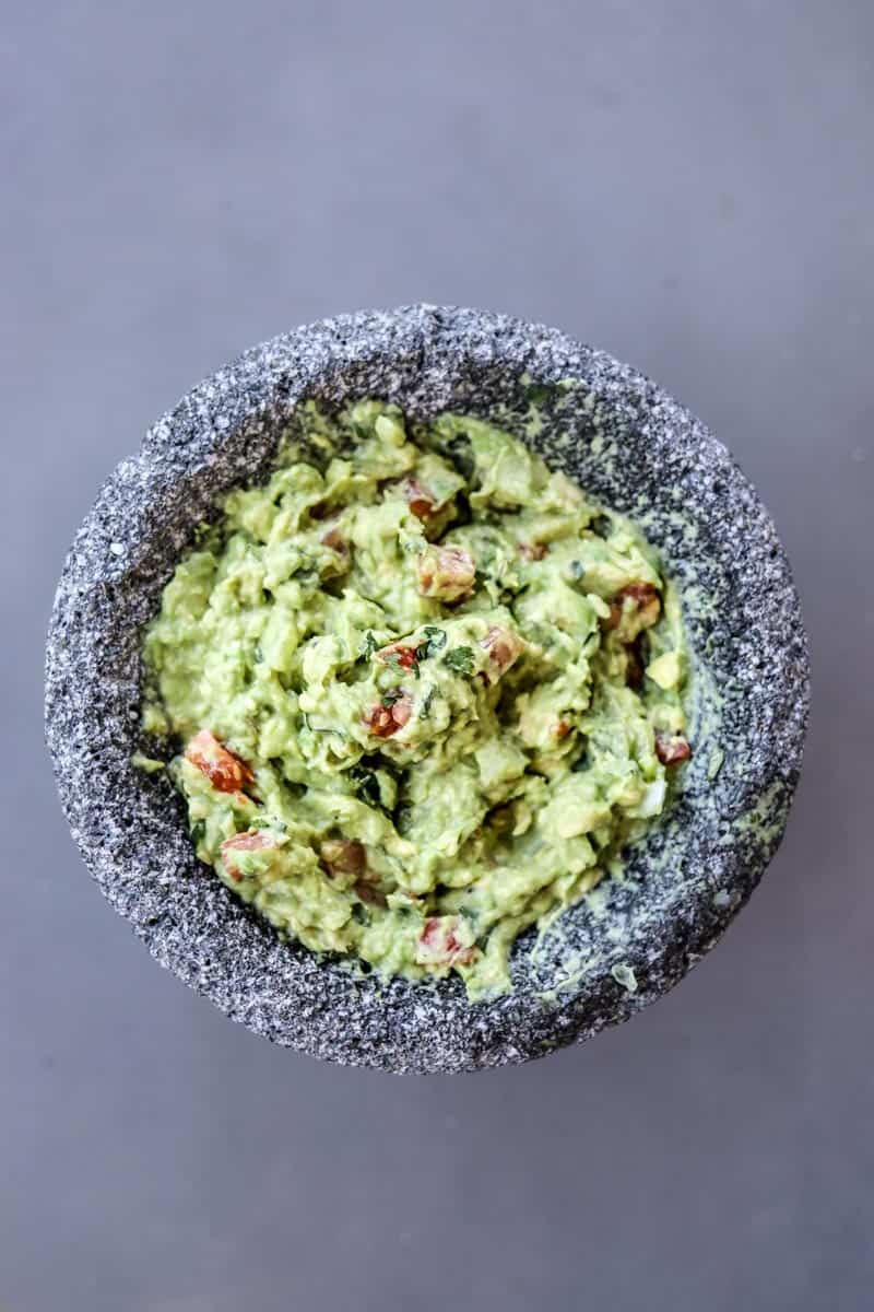 There is regular guacamole, and then there is perfect homemade guacamole with fresh avocados and the perfect amount of onion, cilantro, salt, and tomatoes!