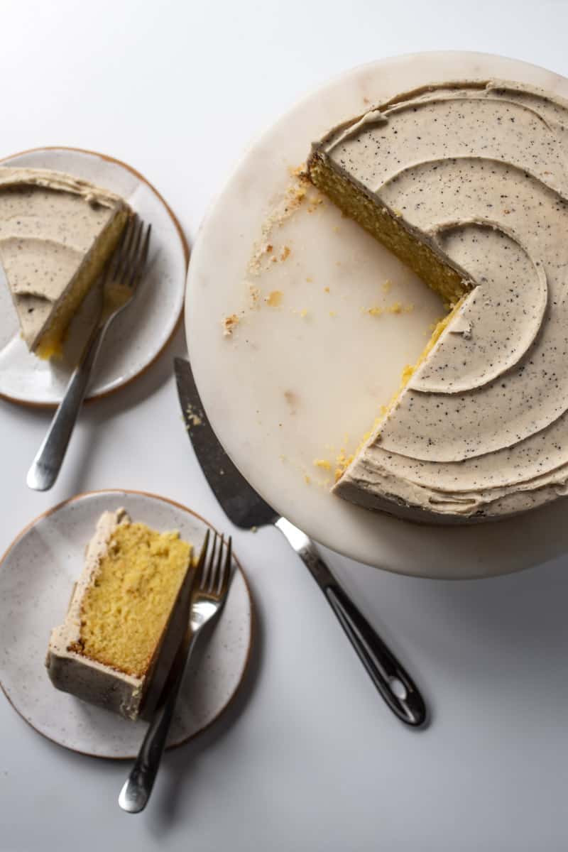 olive oil cake with browned butter frosting, two slices cut out
