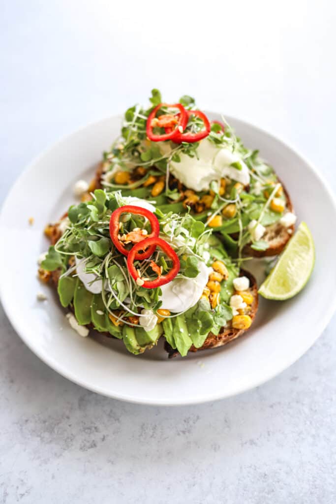 Mexican avocado toast with poached egg on plate