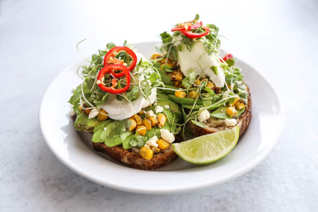 Mexican avocado toast with poached egg on plate