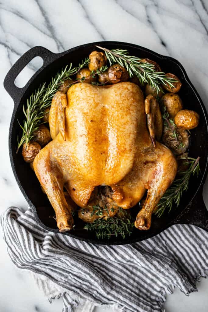 slow roasted chicken with potatoes and rosemary in skillet