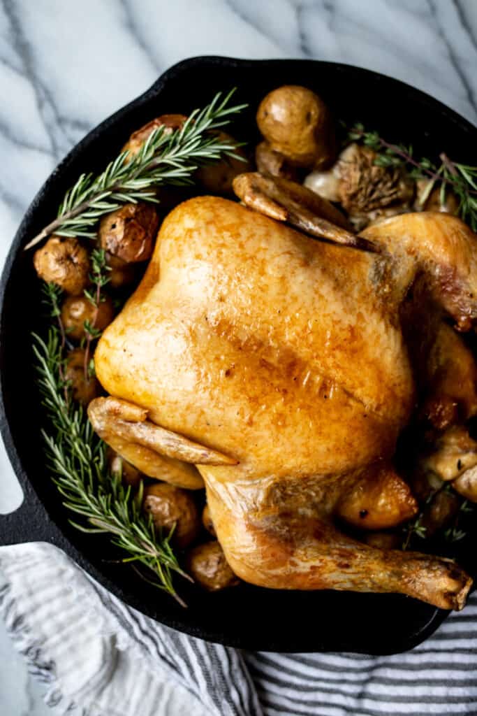 slow roasted chicken with potatoes in skillet