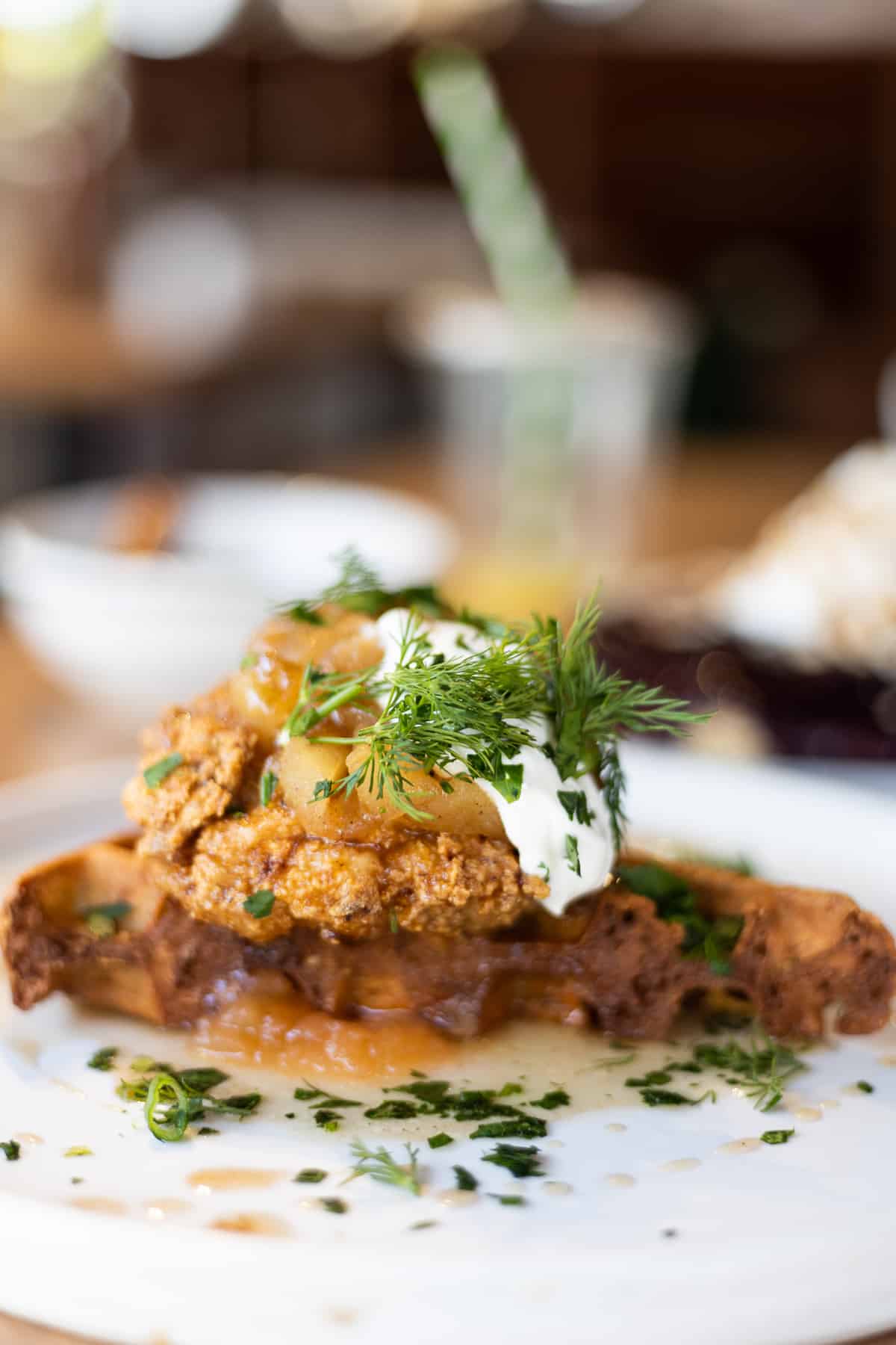potato waffle topped with fried chicken, baked apples, sour cream and fresh herbs laced with plenty of dill by the Hayden