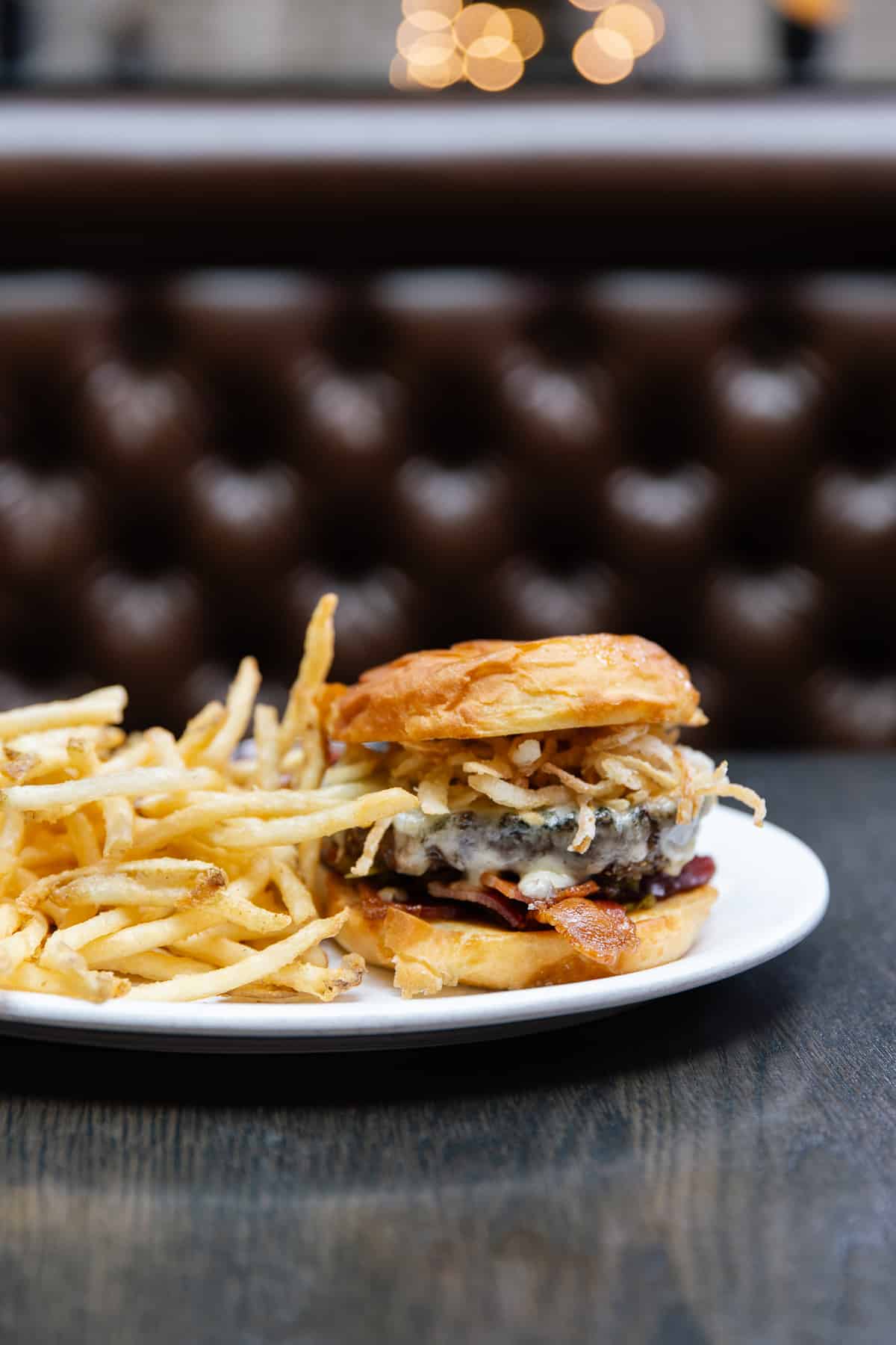 Woodie Fisher's Burger - with Havarti Cheese, smoked bacon, crispy onions, worcestershire aioli, relish and a side of delightfully crispy shoestring fries