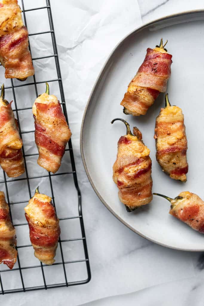 smoked jalapeno poppers on plate and cooling rack