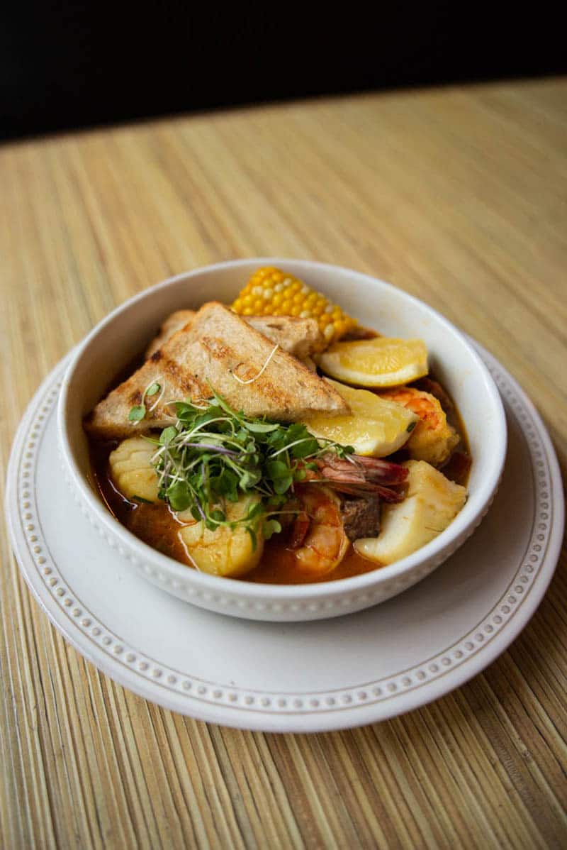 Little Pearl Oyster Bar's cioppino which features shimps and scallops in a rich lobster broth with a side of warm bread