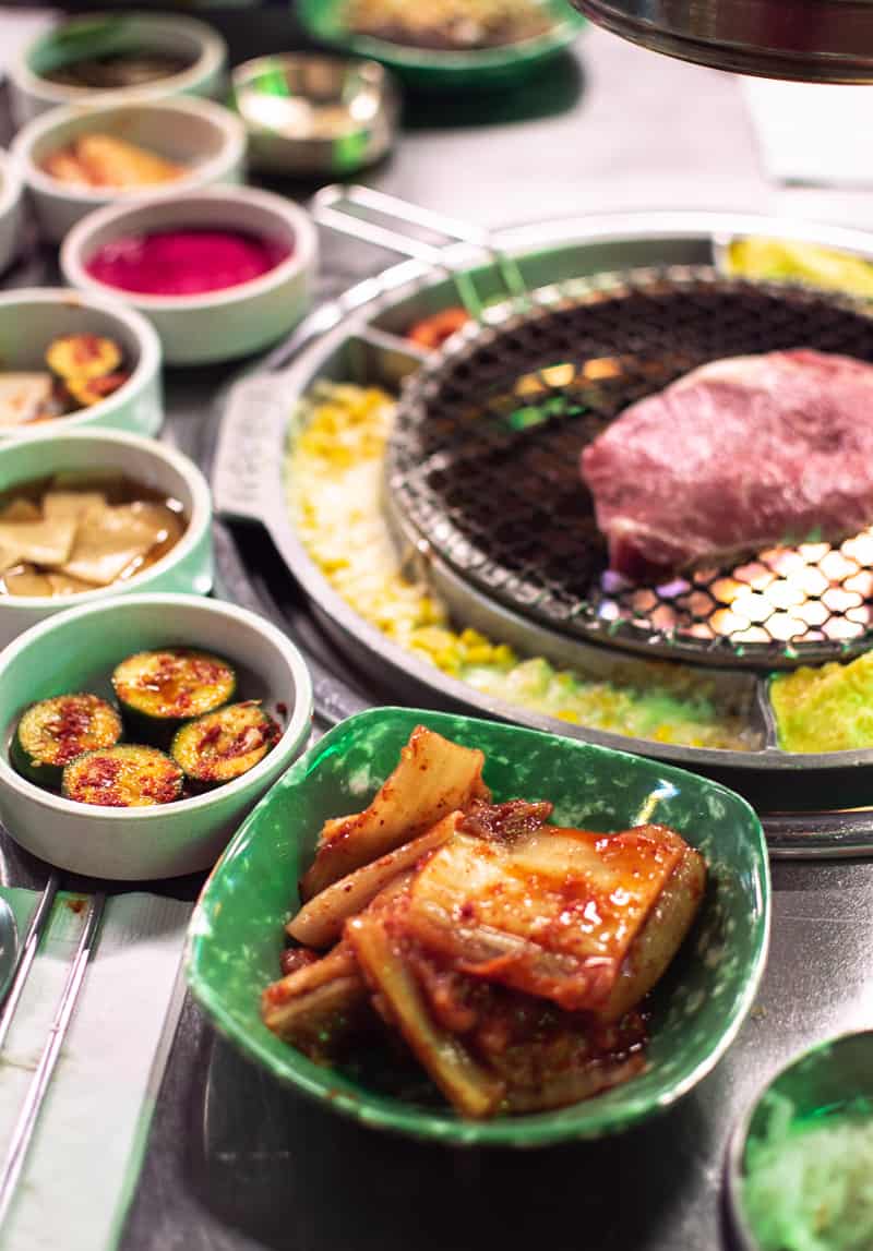 best restaurants in Irvine: Baekjeong Korean BBQ's rib eye steak with sides of kimchi and pickled cucumber