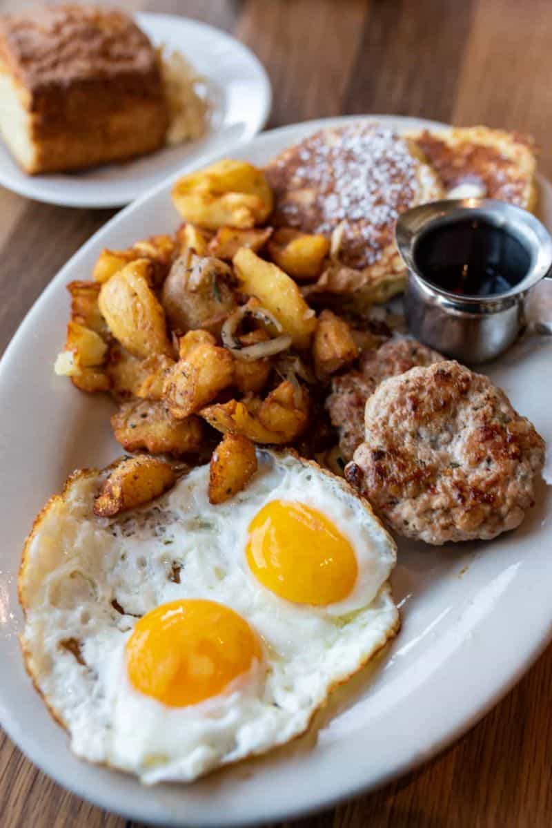 The Plow - a little bit of everything: a pile of potatoes, two eggs, house-made pork sausage patties, and our favorite the lemon ricotta pancakes.