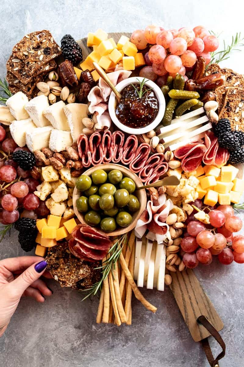Close up view of Thanksgiving Charcuterie with meats, cheeses, olives, crackers, and dried fruit