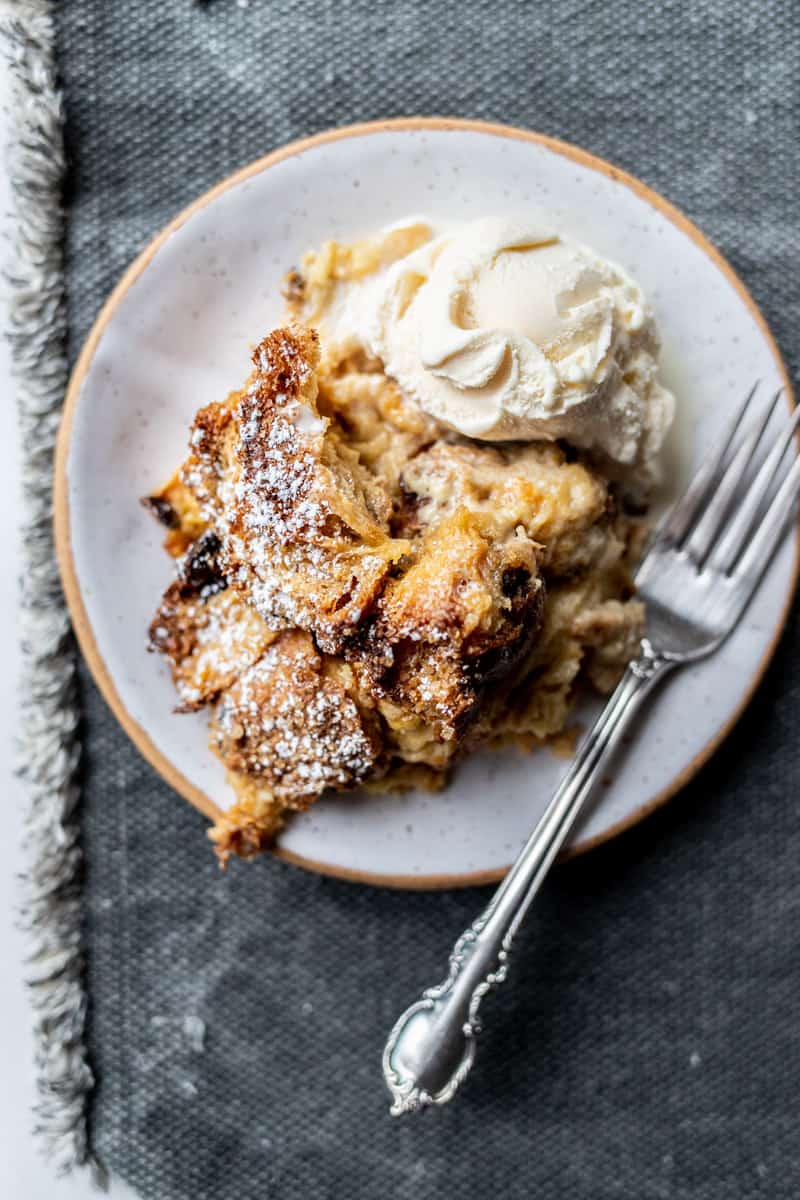 panettone bread pudding on plate with scoop of ice cream