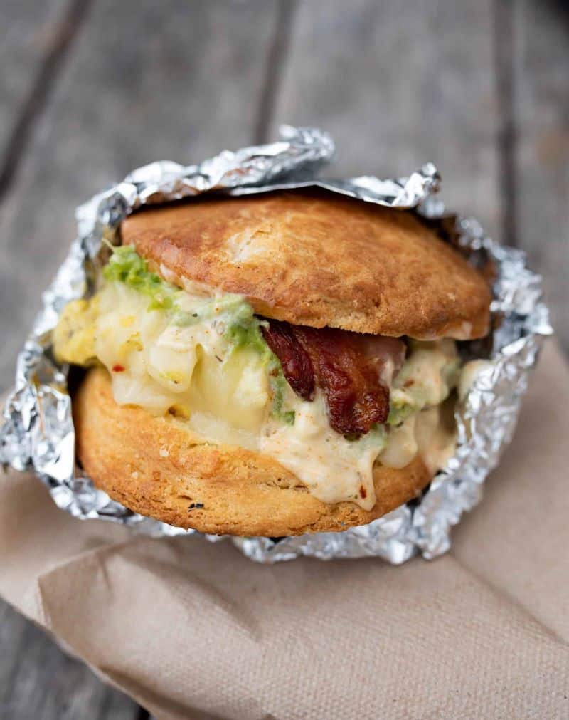 house-made biscuit stuffed with  scrambled eggs, bacon, avocado, melted pepper jack cheese, and lemon-garlic aioli by Devil's Teeth Bakery