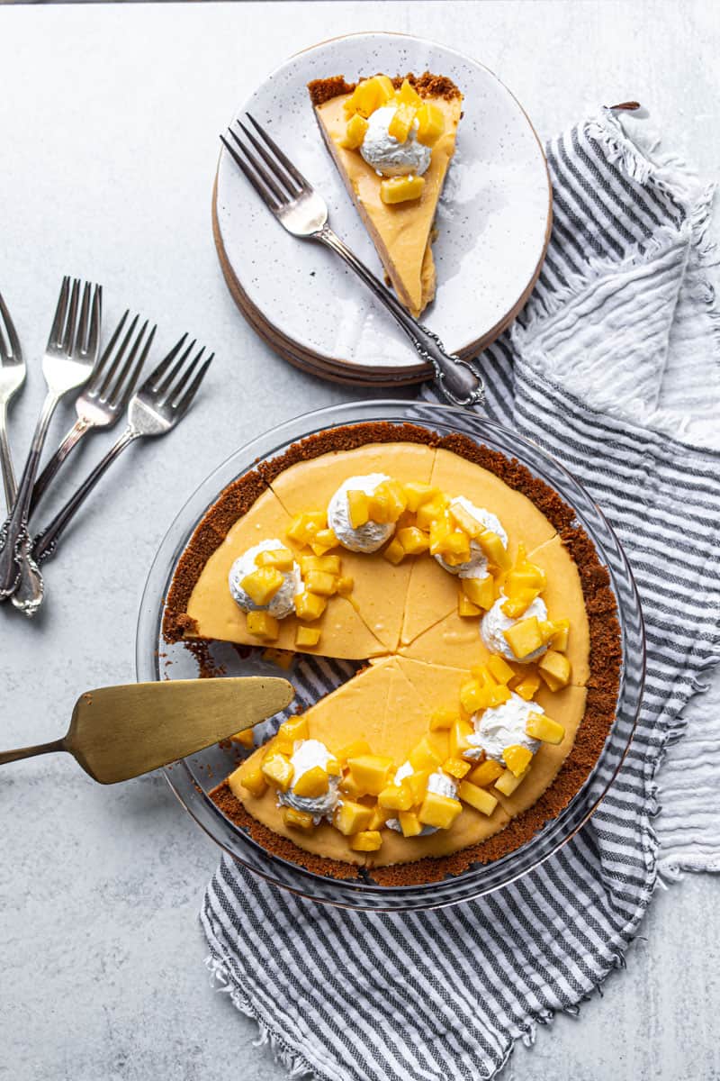 mango pie in pie plate and on serving plates