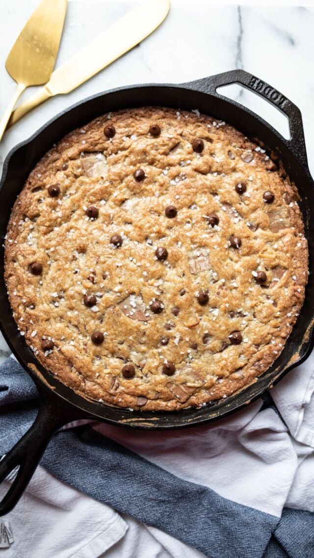 CAST IRON SKILLET COOKIE ⭐️  EQUIPMENT  - 12-inch cast iron skillet  INGREDIENTS  - 1 cup (2 sticks) unsalted butter, slightly softened
- 1 cup brown sugar, packed
- ½ cup granulated sugar
- 2 eggs, cold
- 1 tablespoon vanilla extract
- 2 cups all purpose flour
- 1 teaspoon baking soda
- 1 teaspoon kosher salt
- 1 12-oz package semisweet chocolate chips
- 1 4.4-oz bar high quality milk chocolate, coarsely chopped
- 1 cup coarsely chopped pecans
- 1 cup coconut flakes
- flake salt
- ice cream for serving (optional)  INSTRUCTIONS  1. Preheat the oven to 400°F with the rack positioned in the middle.  2. In a stand mixer or in a large bowl with a hand mixer, cream the butter and sugars until smooth. Add the eggs and vanilla and mix again until smooth. Add the flour, baking soda, and salt and mix once again until just combined (it’s okay if a few traces of flour still remain). Add the semisweet chocolate chips, milk chocolate pieces, pecans, and coconut and mix by hand until combined.  3. Spread the batter evenly into a 12-inch cast iron skillet, using a spatula or offset spatula to make the top surface smooth. Bake for 20-25 minutes until the top surface is a deep golden brown—20 minutes if you prefer your skillet cookie extra gooey and soft inside, 25 if you prefer the cookie with more of a true “cookie” structure once cooled. If the cookie browns too quickly tent the top of the skillet with foil. Remove from the oven, garnish with flake salt, and allow to cool for 10 minutes. Serve warm with ice cream or at room temperature as is.  This recipe is courtesy of the Female Foodie App, where we share exclusive app-only recipes every Friday. To join the app and get access to our full recipe archive, visit femalefoodie.com/app or click the “app” link in our bio.  #femalefoodie #femalefoodierecipe #castironskillet #castironcooking #cookierecipe #giantcookie #skilletcookie #easydessert #easydessertrecipe #cookierecipes
